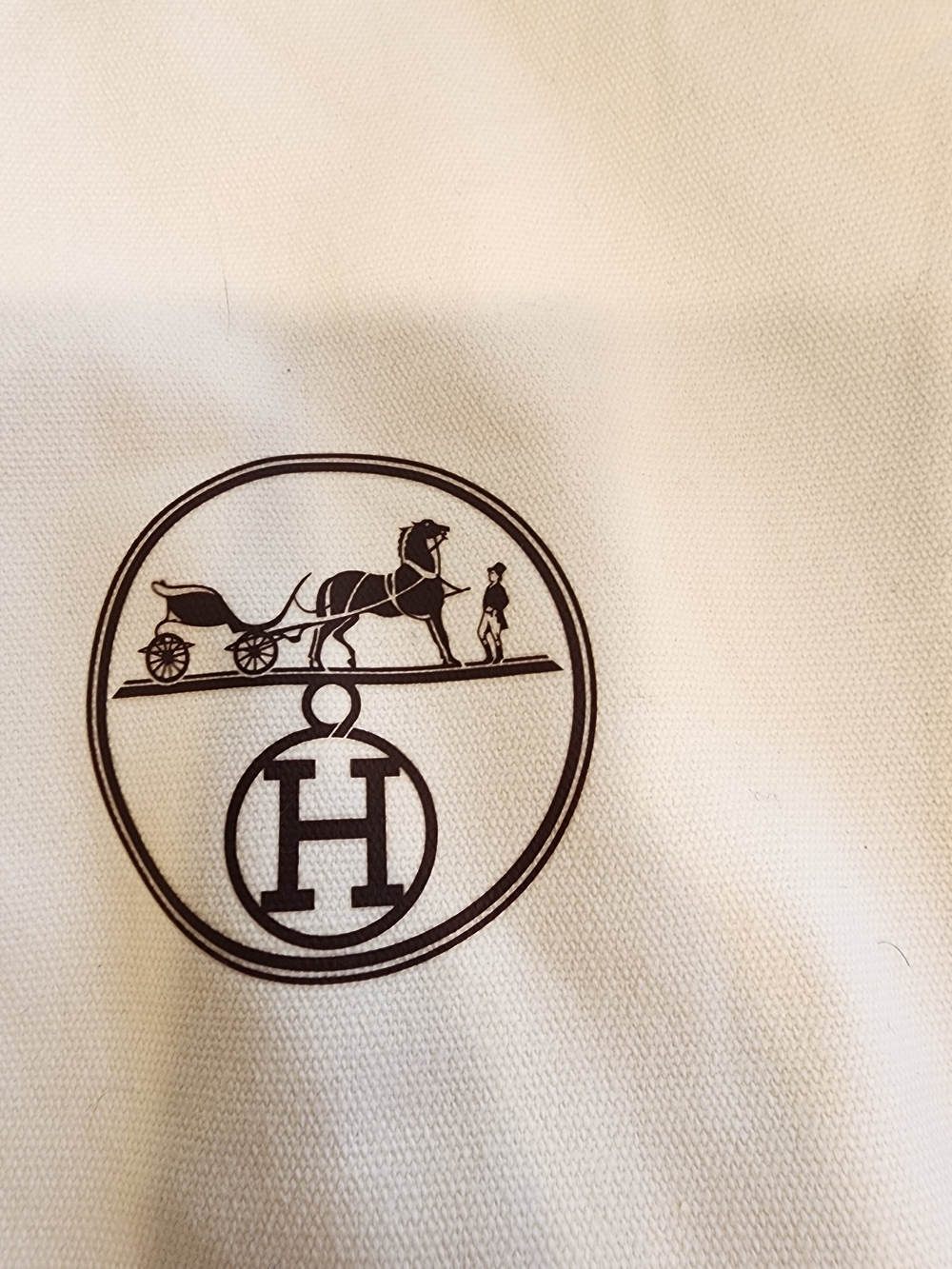 off-white canvas Hermès garment bag features elegant brown piping trim